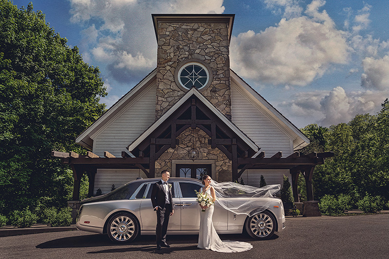 A signature portrait of a Bride and Groom outside the chapel at Ancaster Mill