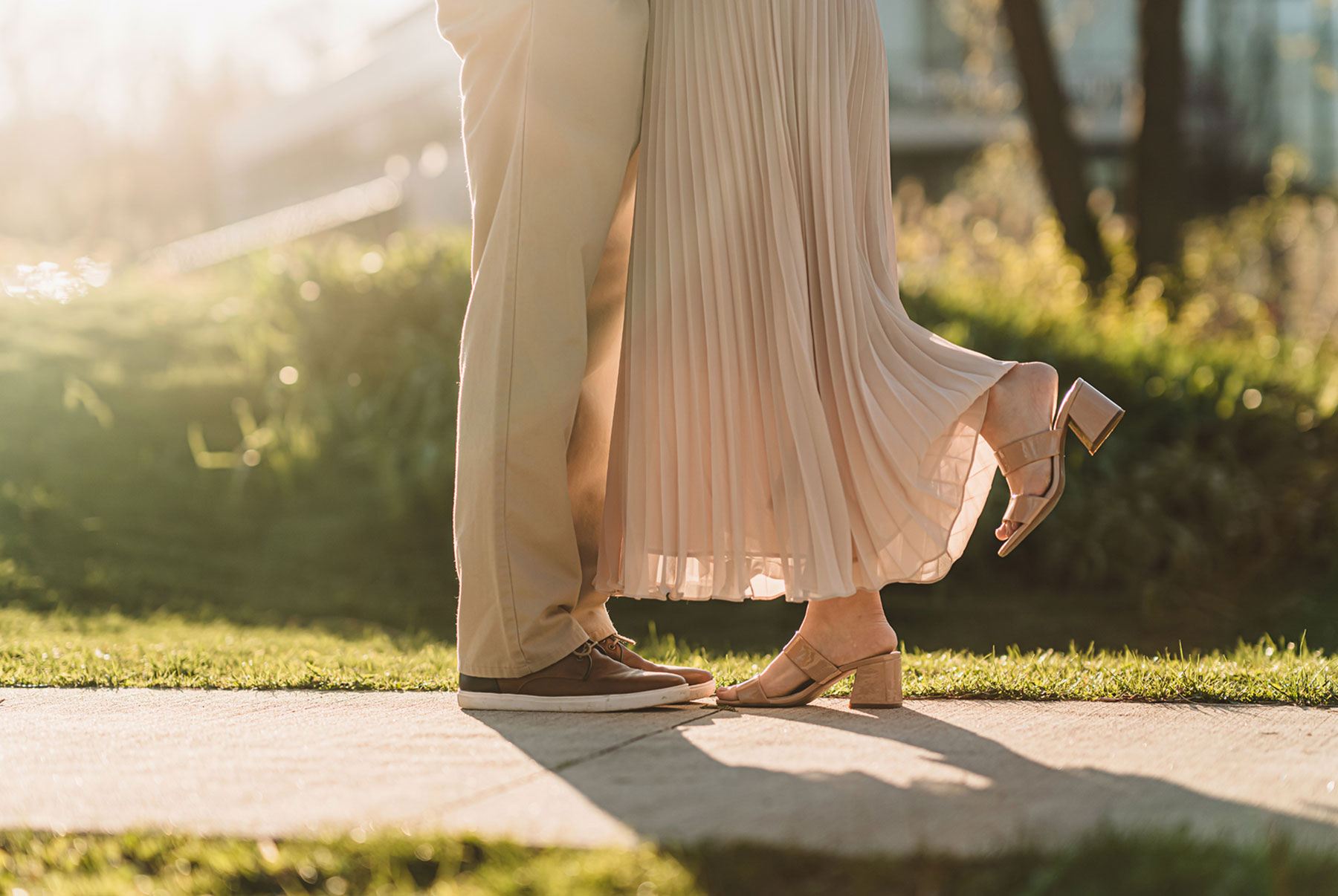 A couple on their engagement shoot, with an urban landscape in the background.